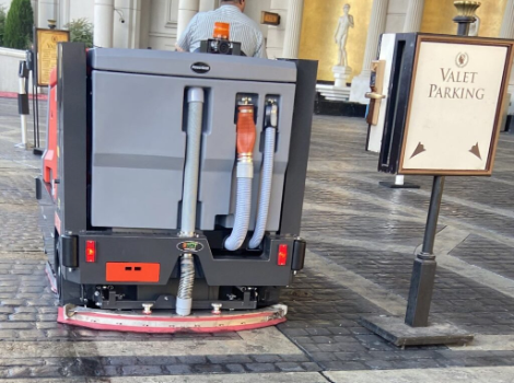 PowerBoss sweeper-scrubber cleaning a valet parking area